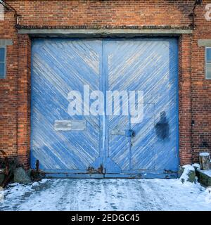 Blue wooden door of an old warehouse Stock Photo