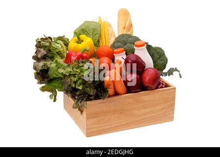 Wooden crate with multi collor vegetables , fruit, milk and baguette isolated on white background. Grocery in wood crate . Save with clipping path Stock Photo