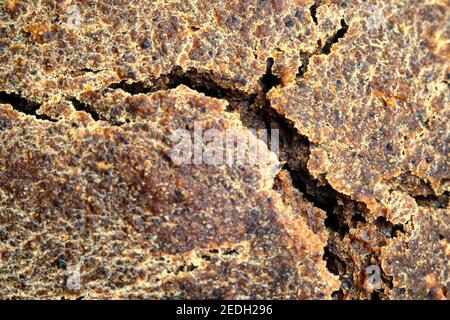 Natural cracks on the brown crust of rye bread close-up Stock Photo