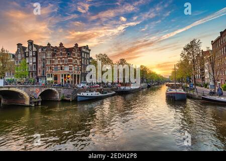 Amsterdam Netherlands, sunset city skyline of Dutch house at canal waterfront Stock Photo