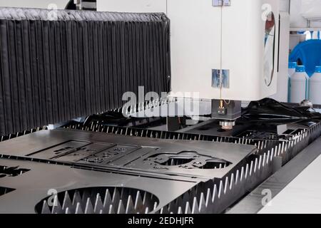 Laser cutting machine working with sheet metal at metalworking exhibition Stock Photo