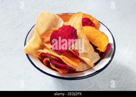 Fruit and vegetable chips in a bowl, a healthy vegan snack Stock Photo