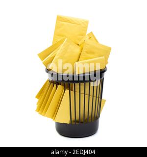 Trash bin filled with yellow bubble envelopes Stock Photo