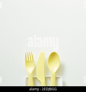 Yellow fork knife spoon on white background. flat lay, top view, copy space Stock Photo