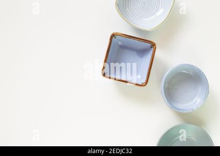 Colorful empty plates on white background. flat lay, top view, copy space Stock Photo