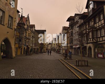 Pedestrian zone in historic town center on cloudy winter day. Orange colored sky due to rare weather phenomenon (Sahara desert sand in air). Stock Photo