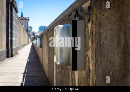 Electric lamp in plafond on old stone wall. Stock Photo