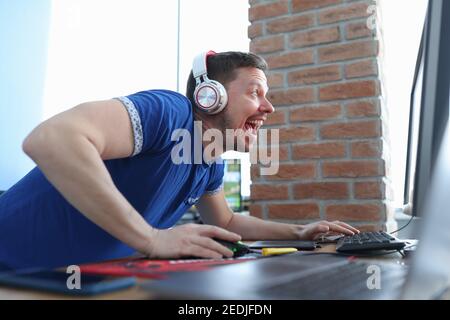 Young man with headphones playing computer game Stock Photo