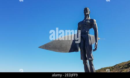 Statue of a surfer in the beach of Ribeira d'Ilhas World Surf Reserve. Ericeira in Portugal. October 04, 2018. Stock Photo