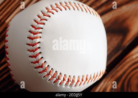 White baseball ball close up with red thread in stitching - macro photo Stock Photo