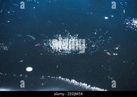 Air bubbles under the ice - frozen water on the lake - winter frost Stock Photo