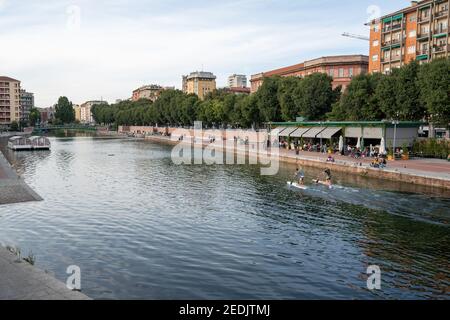 Milan,Italy-september 29,2020:People walk along the shore of the Naviglio Milanese canal and relax in the bars during the coronavirus pandemic (Covid- Stock Photo