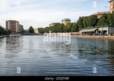 Milan,Italy-september 29,2020:People walk along the shore of the Naviglio Milanese canal and relax in the bars during the coronavirus pandemic (Covid- Stock Photo