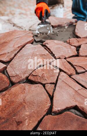 Facing the concrete floor with decorative stone - natural covering from natural tiles Stock Photo