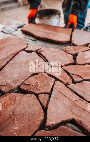 Facing the concrete floor with decorative stone - natural covering from natural tiles Stock Photo