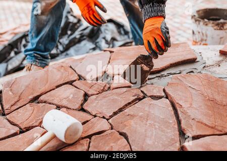 Facing the concrete floor with decorative stone - natural covering from natural tiles Stock Photo