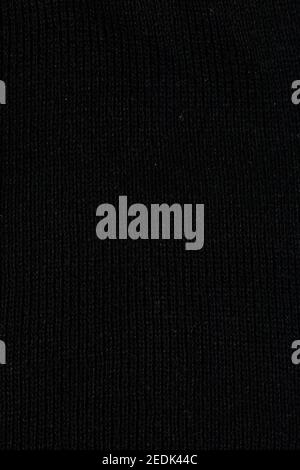 black fabric surface, small stitches as background. Structure of dark fabric as pattern backdrop. Stock Photo