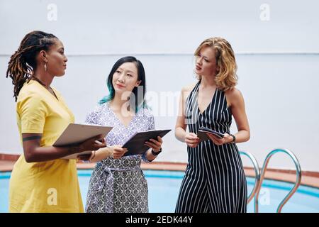 Talking female colleagues Stock Photo