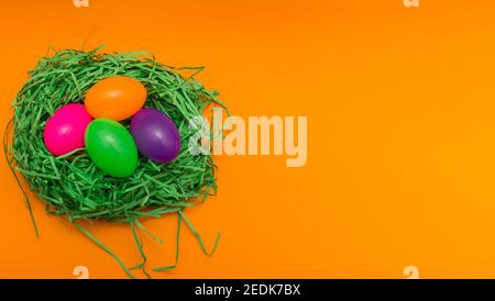 Four Colorful Easter Eggs Sitting in Green nest or Grass.Studio image. Stock Photo
