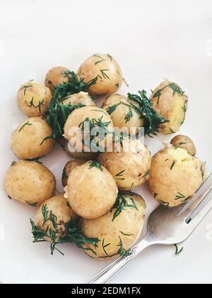 Boiled young potato with butter and herbs Stock Photo