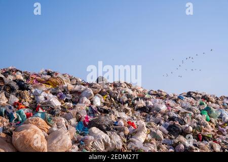 large garbage pile, global warming on sky background Stock Photo