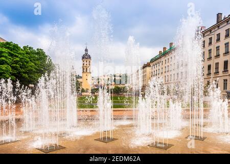 Place Antonin Poncet and its fountain, and the bell tower of charity in the background in Lyon, in the Rhône, France Stock Photo
