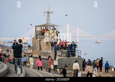 Wuhan China , 14 February 2021 : Crowd of people enjoying 2021 Chinese new year week holidays on Yangtze riverbanks in Wuhan Hubei China Stock Photo