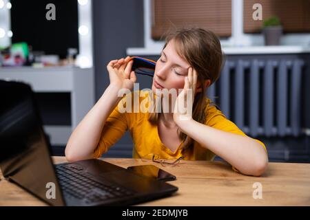 Calm peaceful young woman relaxing in office chair at workplace, tired employee sitting at desk, female student taking break after study, meditating Stock Photo