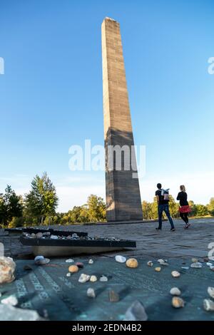 19.09.2020, Lohheide, Lower Saxony, Germany - Bergen-Belsen memorial, obelisk, small commemorative stones in front, placed by Jewish visitors. In the Stock Photo