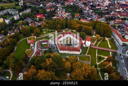 Sarvar, Hungary - Aerial panoramic view of the Castle of Sarvar (Nadasdy castle)  with golden coloured trees and foliage on a calm autumn morning Stock Photo