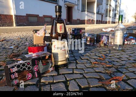 02.01.2020, Berlin, Saxony, Germany - New Year's Eve fireworks packaging and bottles on a pavement.. 00S200102D297CAROEX.JPG [MODEL RELEASE: NO, PROPE Stock Photo