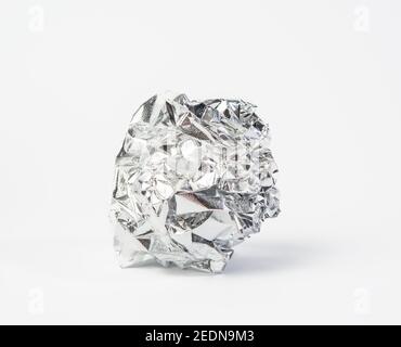 crumpled piece of gray foil on a white background, close up Stock Photo