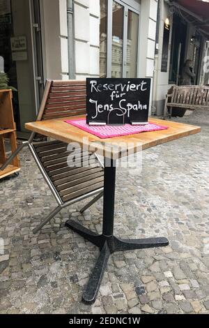 21.01.2021, Berlin, , Germany - Sign saying Reserved for Jens Spahn stands on a table in front of a cafe.. 00S210121D657CAROEX.JPG [MODEL RELEASE: NO, Stock Photo