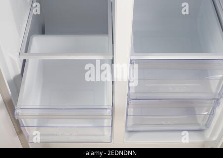 Home appliance - Inside closeup open two-door white refrigerator freeze and fresh zone Stock Photo