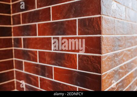 Ceramic facade tiles imitation red brick - exterior wall and facade decoration Stock Photo