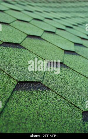 Bituminous shingles - roofing material based on fiberglass, modified bitumen and stone dusting granulate - soft roof Stock Photo