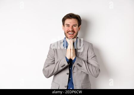 Handsome caucasian man say thank you, bowing with namaste gesture ...