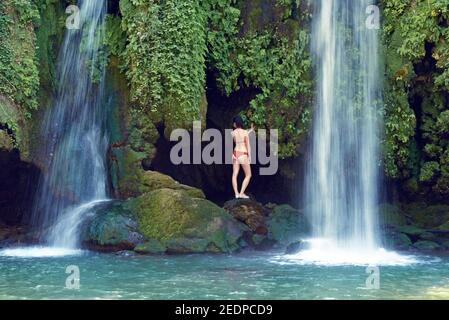 woman in bikini under the waterfall Cascade du Baou, France, Provence, Dept Var, Le Val Stock Photo