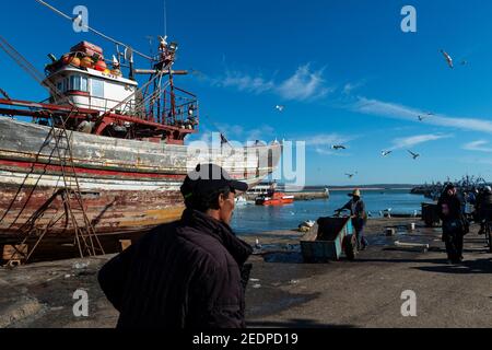 Essaouira, Morocco - April 15, 2016: Fisherman in the harbor at the city of Essaouira, with the the traditional fishing boats, in the Atlantic Coast o Stock Photo