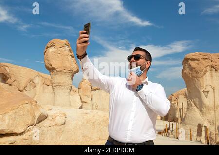 Lonely male tourist at Al Qarah Mountain in Eastern province of Saudi Arabia Stock Photo