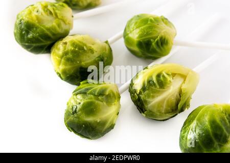 Set of brussel sprouts with lollipop sticks on white background Stock Photo