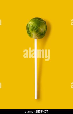 Set of brussel sprouts with lollipop sticks on yellow background Stock Photo