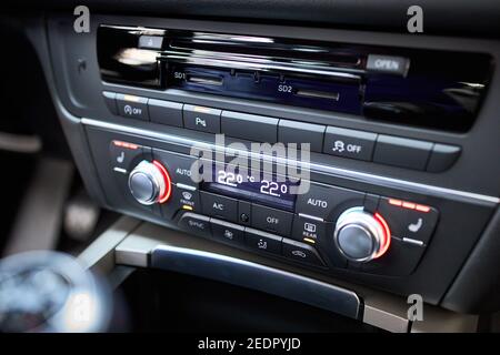 Modern car climate control panel for driver and passenger with shallow depth of field. Zone climate control. Car interior detail. Multimedia radio cd Stock Photo