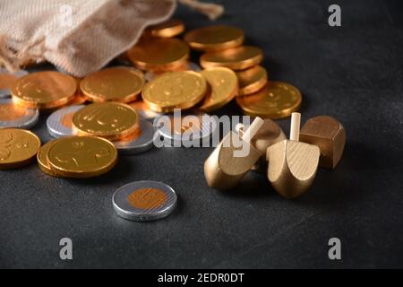 Hanukkah Chocolate shekel Coins. Delicious chocolate shekels in golden package. Hanukkah gelt with menorah. Stock Photo