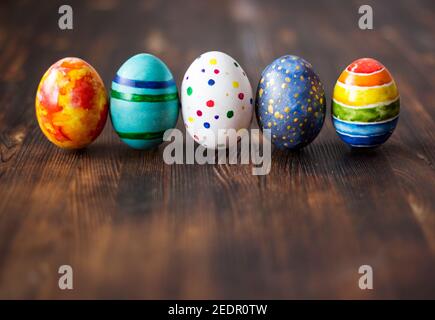 Easter colorfully painted eggs on wooden background. Stock Photo