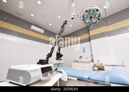 fractional laser against the background of a modern operating room in a cosmetology or dermatological clinic. Stock Photo