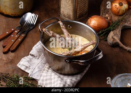 Stewed rabbit legs with sour cream Stock Photo
