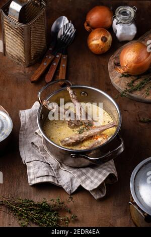 Stewed rabbit legs with sour cream Stock Photo