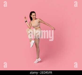 Sporty Young Woman Exercising Isolated On Pink Background Stock Photo