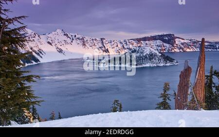 Wizard Island at Crater Lake inside caldera in ancient volcano seen from Rim Village at sunrise in winter, Crater Lake National Park, Oregon, USA Stock Photo
